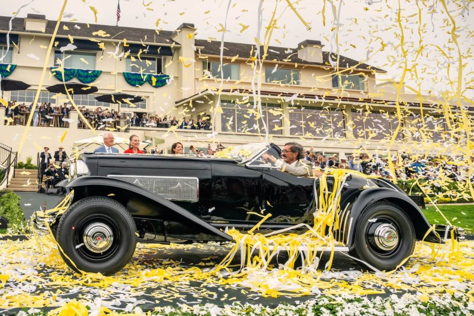The 1935 Duesenberg SSJ Special Speedster celebrating its Best of Show victory at the 75th Pebble Beach Concours d’Elegance
