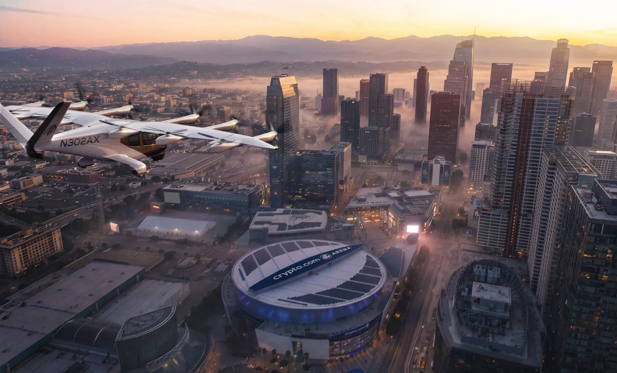 Archer Midnight electric air taxi flying above downtown Los Angeles and the L.A. LIVE arena district at sunset.