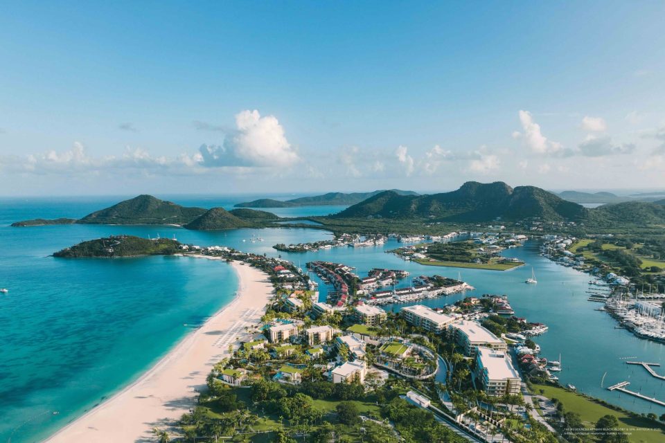Aerial view of Jolly Beach and Jolly Harbour in Antigua showing the Nikki Beach Resort and Residences site between turquoise sea and marina.