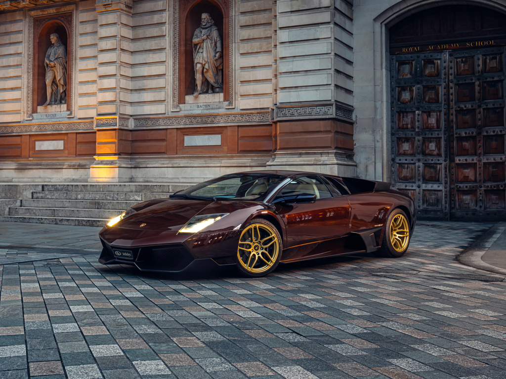 Front three-quarter view of the Marrone Eklipsis Lamborghini Murciélago LP 670-4 SV at dusk.