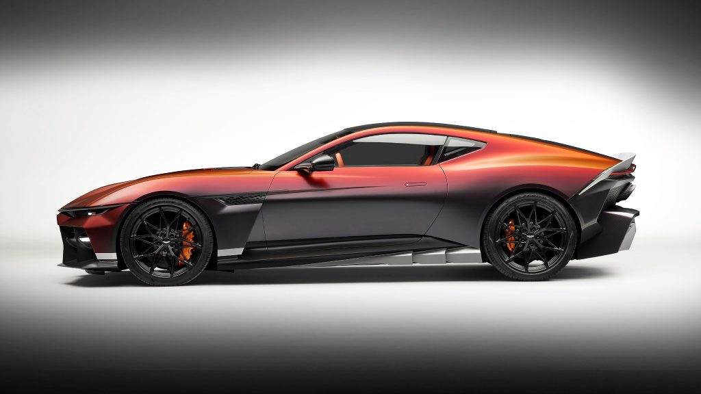 Side profile of the Aston Martin Valen showing its long front-engined proportions, black roof, magnesium wheels and sculpted aerodynamic sills.