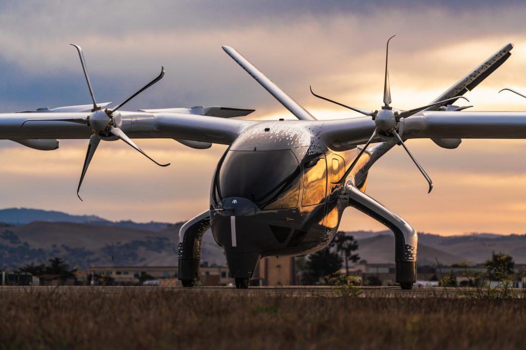 Black Archer Midnight electric vertical take-off and landing aircraft photographed on the ground at sunset.