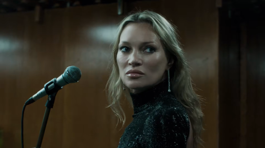 Kate Moss at a microphone in Gucci Primavera campaign film And We Shall Dance Again