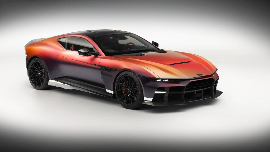 Front three-quarter view of the Aston Martin Valen highlighting its Satin Andromeda Red finish, carbon fibre bodywork and aggressive front stance.