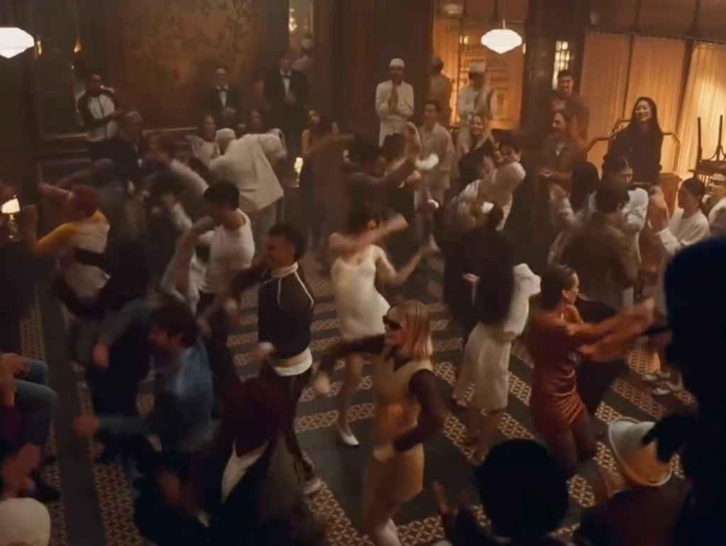 Crowd dancing inside the Parisian café in the CHANEL COCO MADEMOISELLE CRUSH ABSOLU campaign