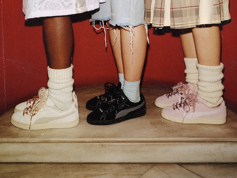 Close view of PUMA Suede Bloom trainers in Vintage Cream, Black and Powder Pink worn with layered socks.