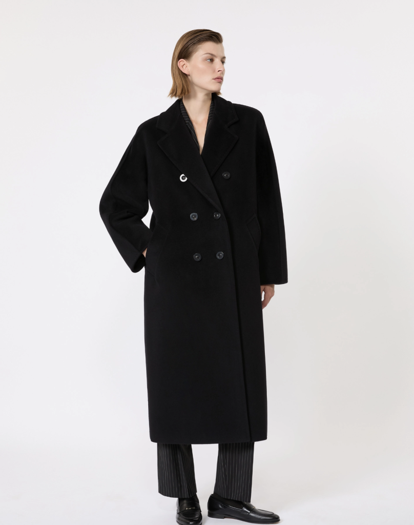 Model wearing a black double-breasted Max Mara coat in a studio product image.