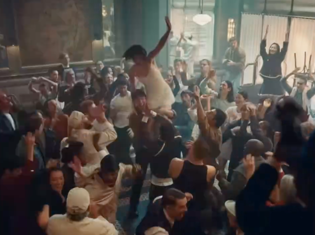 Gracie Abrams crowd-surfing above dancers in the CHANEL COCO MADEMOISELLE CRUSH ABSOLU campaign