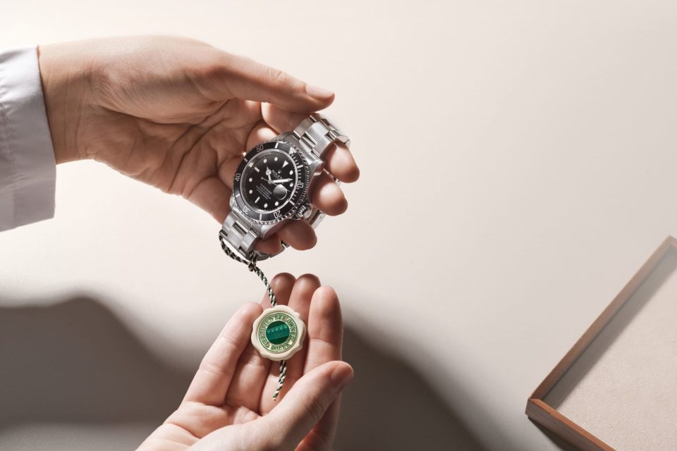A Rolex Certified Pre-Owned watch presented with its distinctive green-and-white certification seal