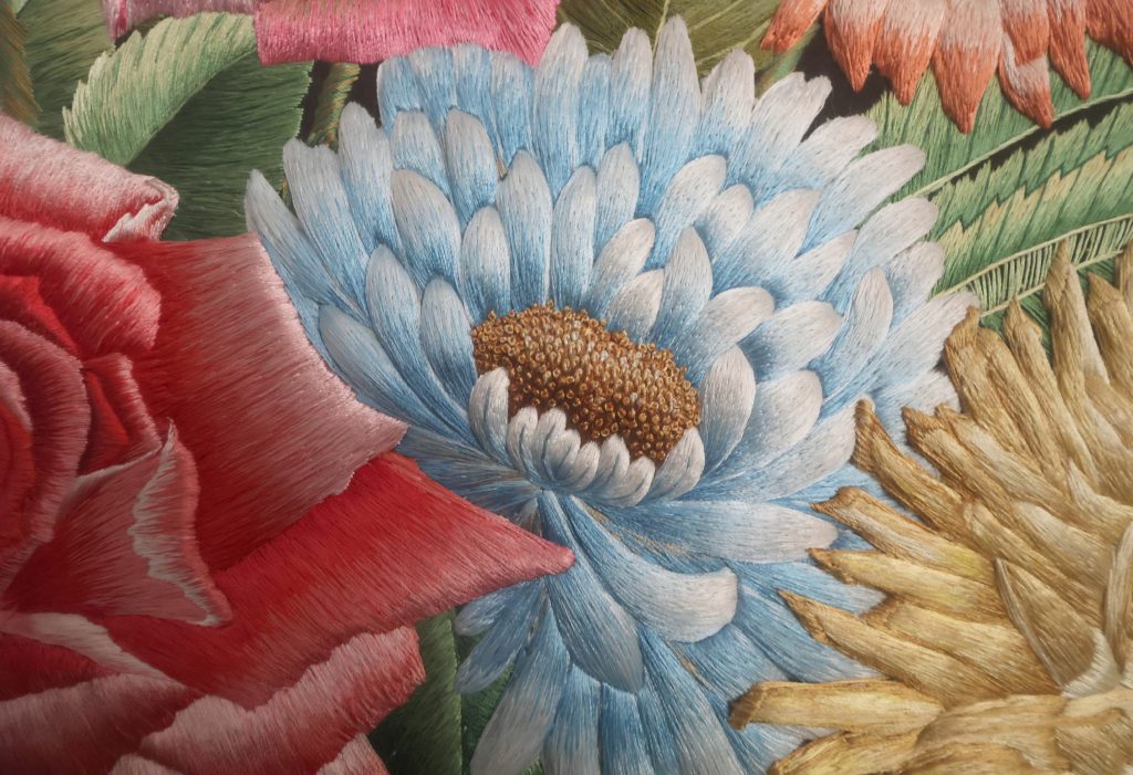Silk flowers in Shams Uddin The Vase, showing the depth and detail of the hand embroidery.