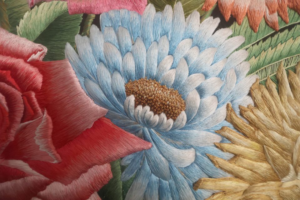 Silk flowers in Shams Uddin The Vase, showing the depth and detail of the hand embroidery.