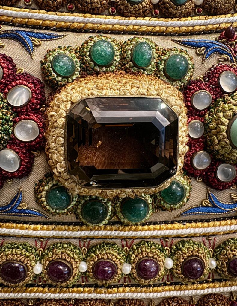 Faceted centrepiece stone and its intricate embroidered surround in The Vase.