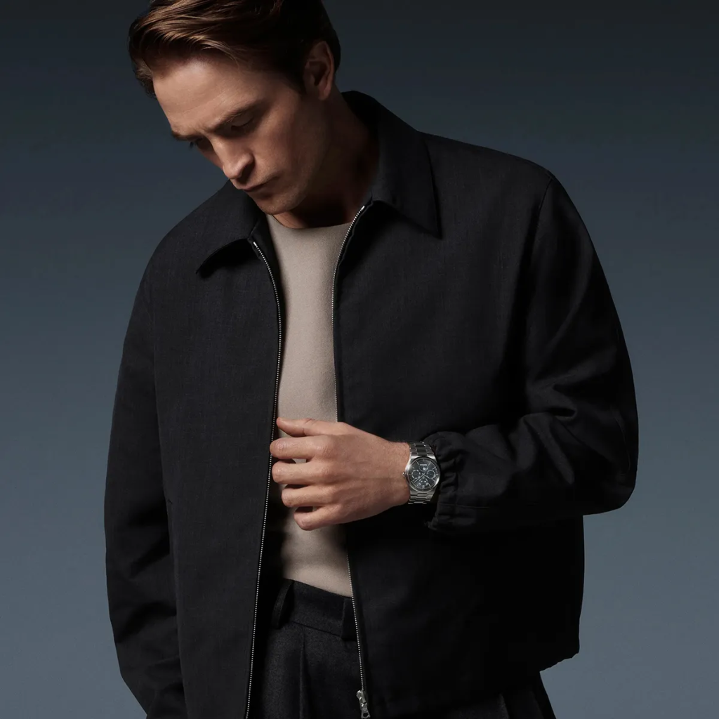 Robert Pattinson looking towards the stainless-steel Jaeger-LeCoultre Master Control Chronometre Perpetual Calendar with its blue-grey dial.