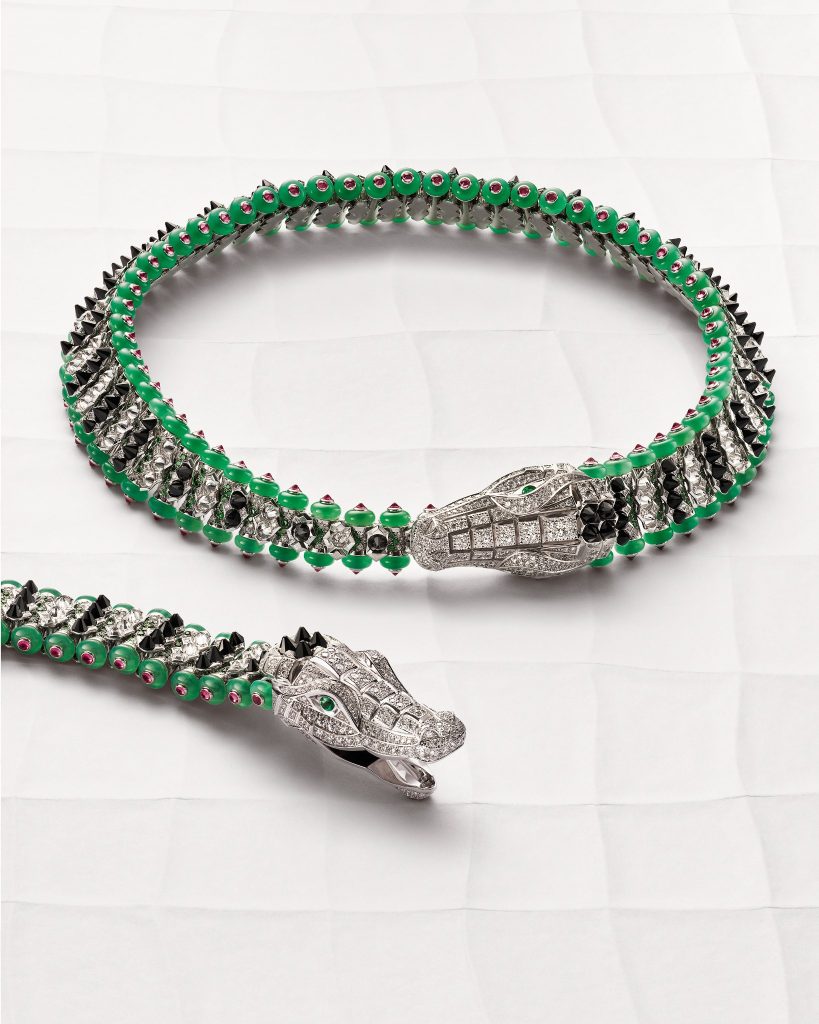 Vertical view of Cartier’s articulated crocodile bracelet and necklace with diamond-set heads, black onyx crest spikes and green chrysoprase borders.