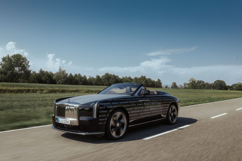 Black Rolls-Royce Project Nightingale prototype driving on an open road