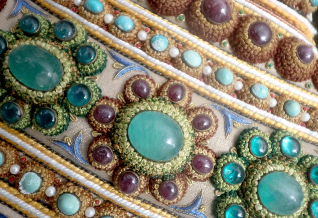 Emerald cabochons, gemstones, pearls and gold threadwork in the jewelled vessel of The Vase.