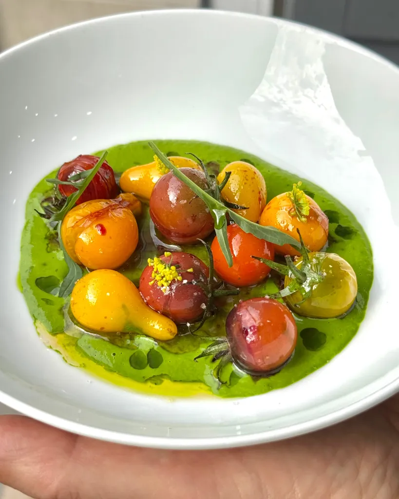 Close-up detail of heirloom and specialty tomatoes in jewelled tones, highlighting texture and individual character of each fruit