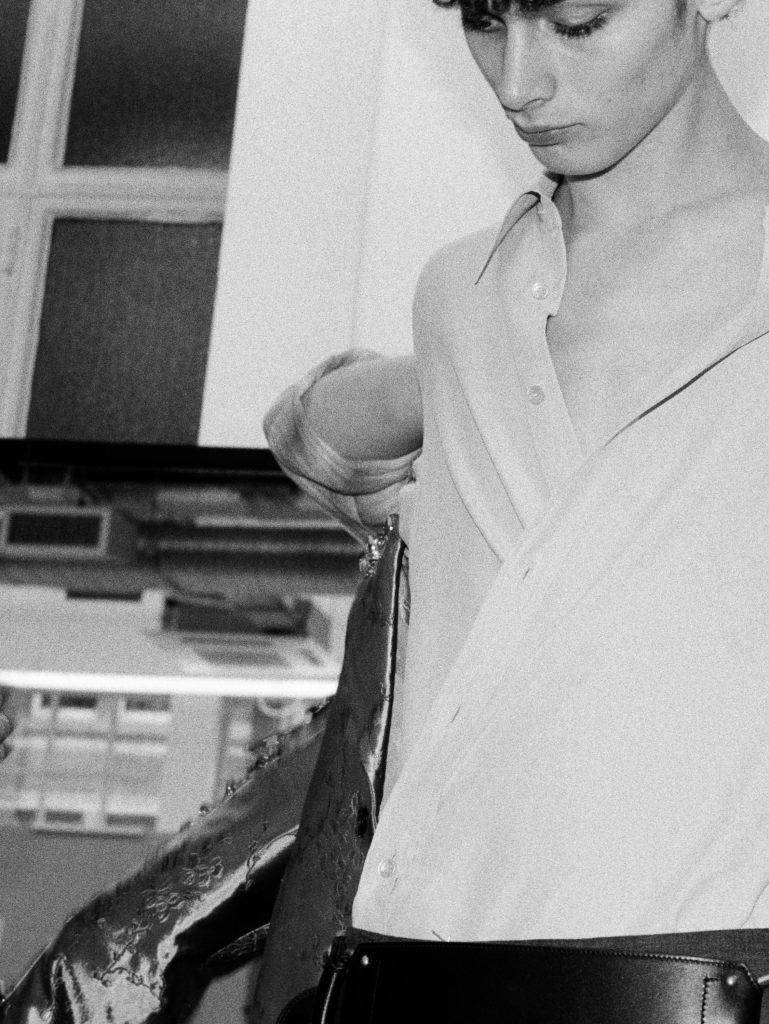 Model wearing complete look with luminous jacquard and metallic detailing