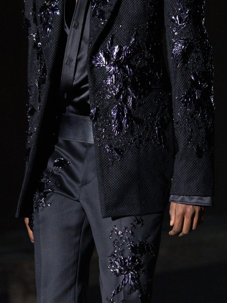 Side profile of model in evening garment with iridescent detailing