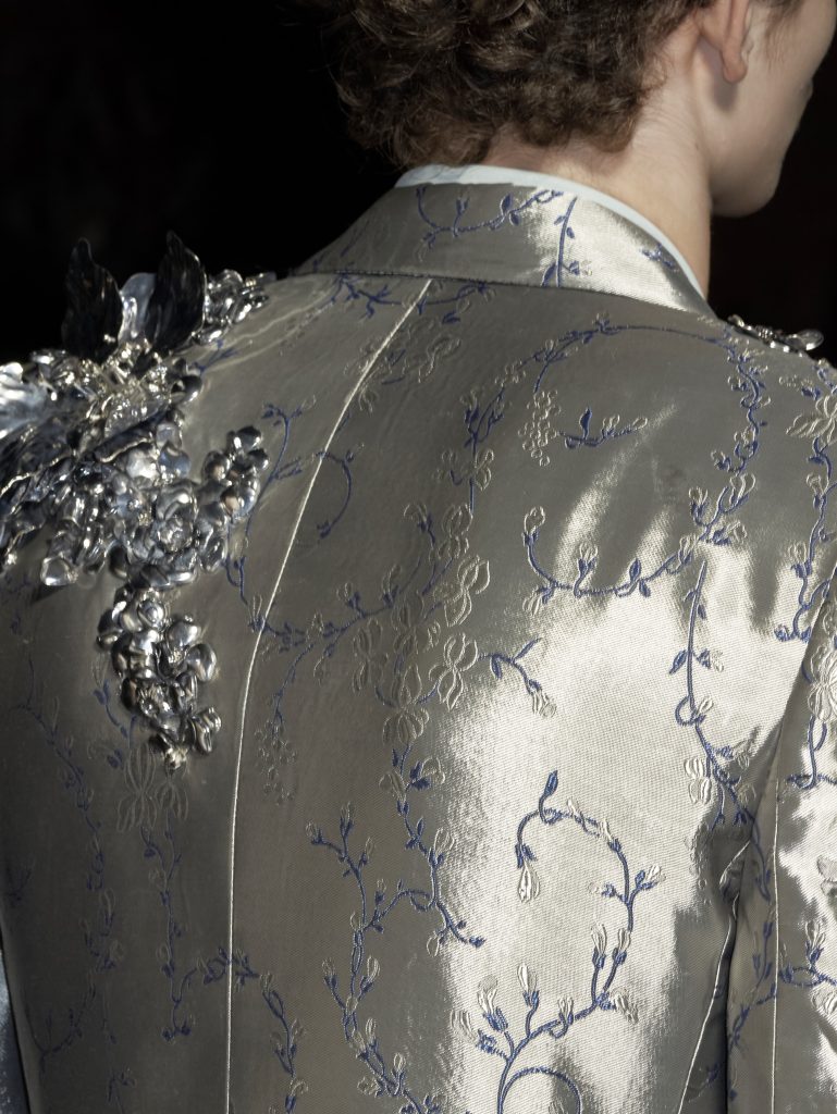 Full length image of garment featuring laser cut metallic elements