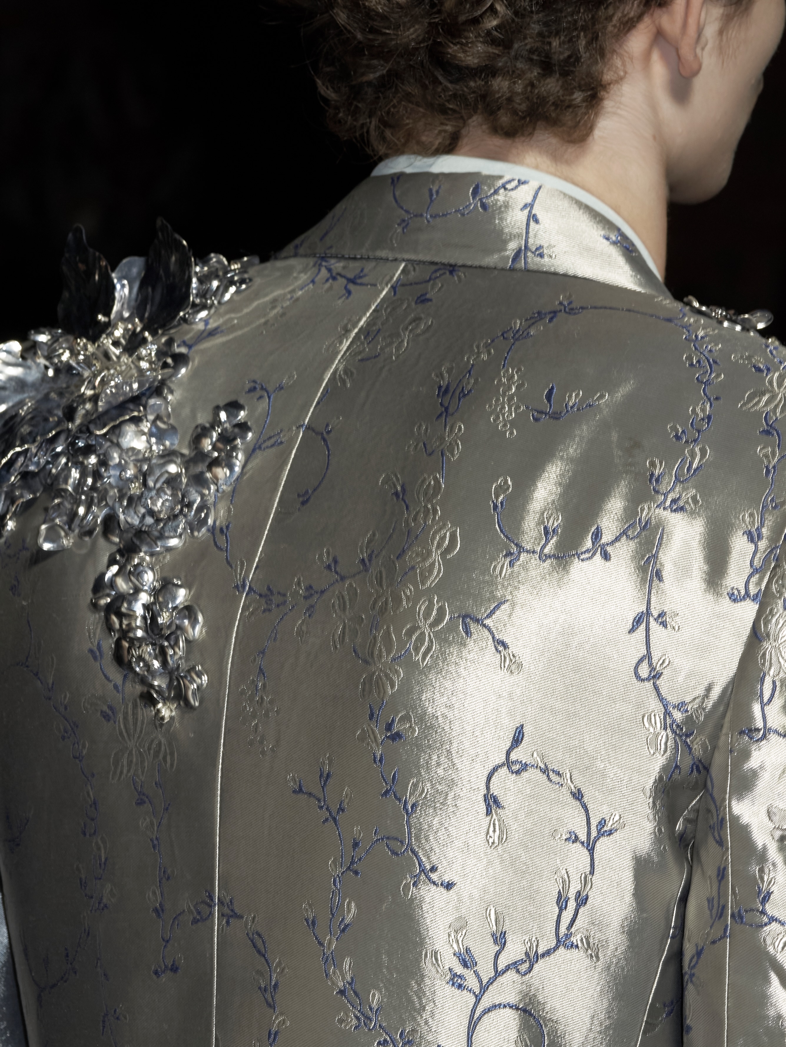Full length image of garment featuring laser cut metallic elements