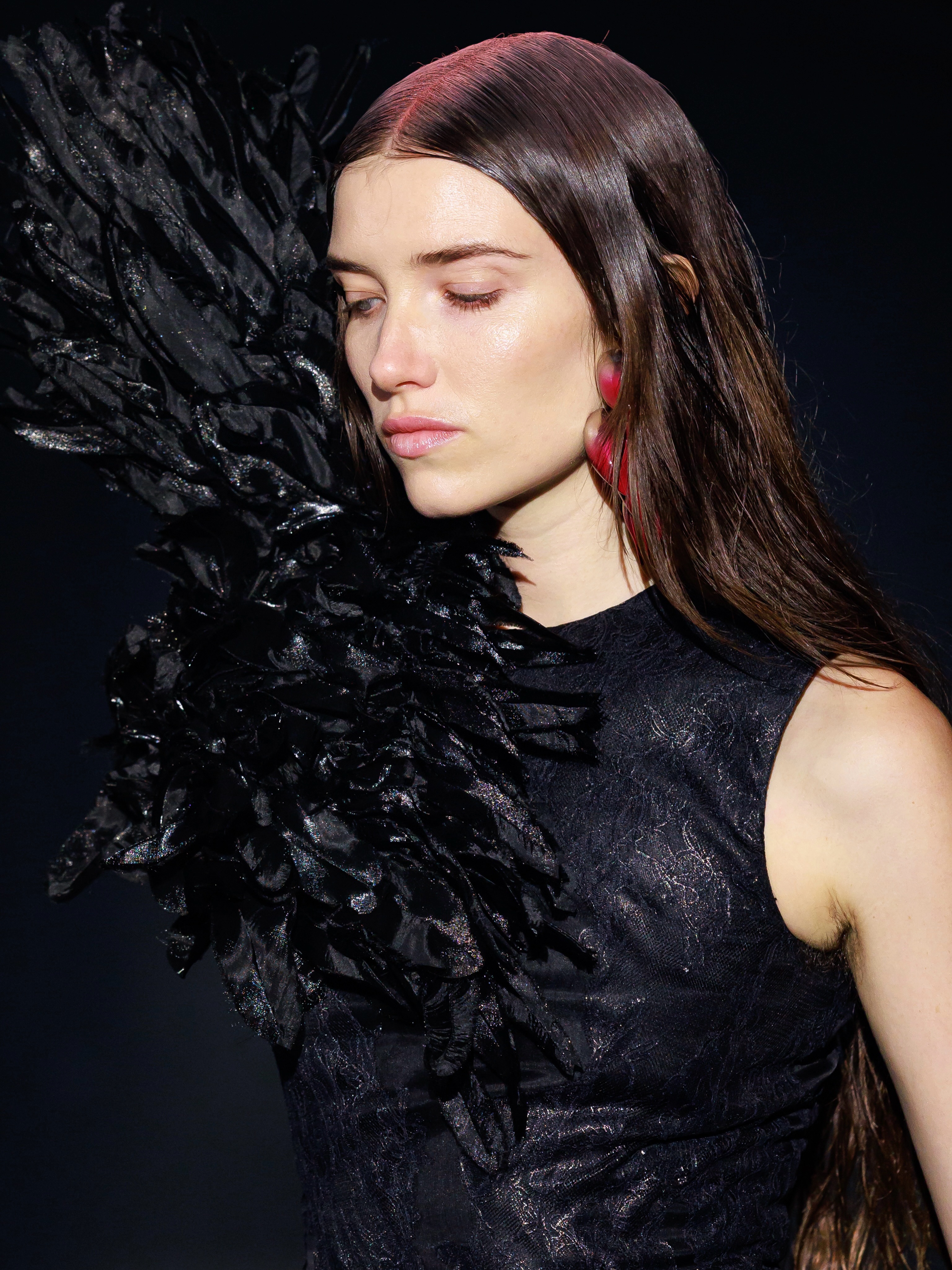 Full silhouette of feather-embellished black evening look