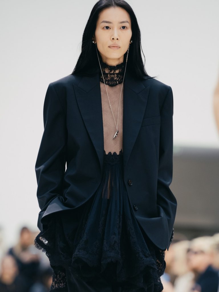 Model in soft pastel pink ensemble showcasing Pierpaolo Piccioli's refined minimalism