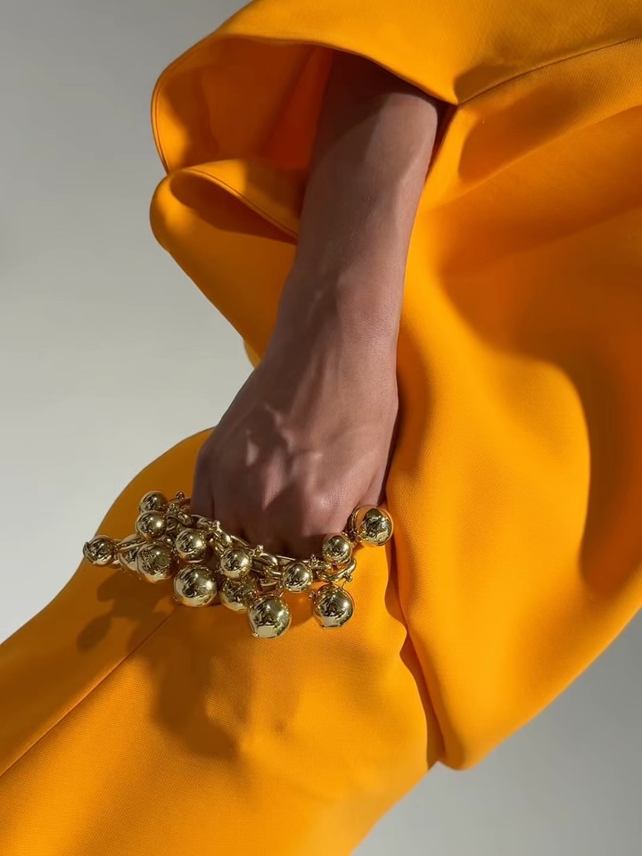 Layered coral tones creating tonal depth in the Summer 27 collection