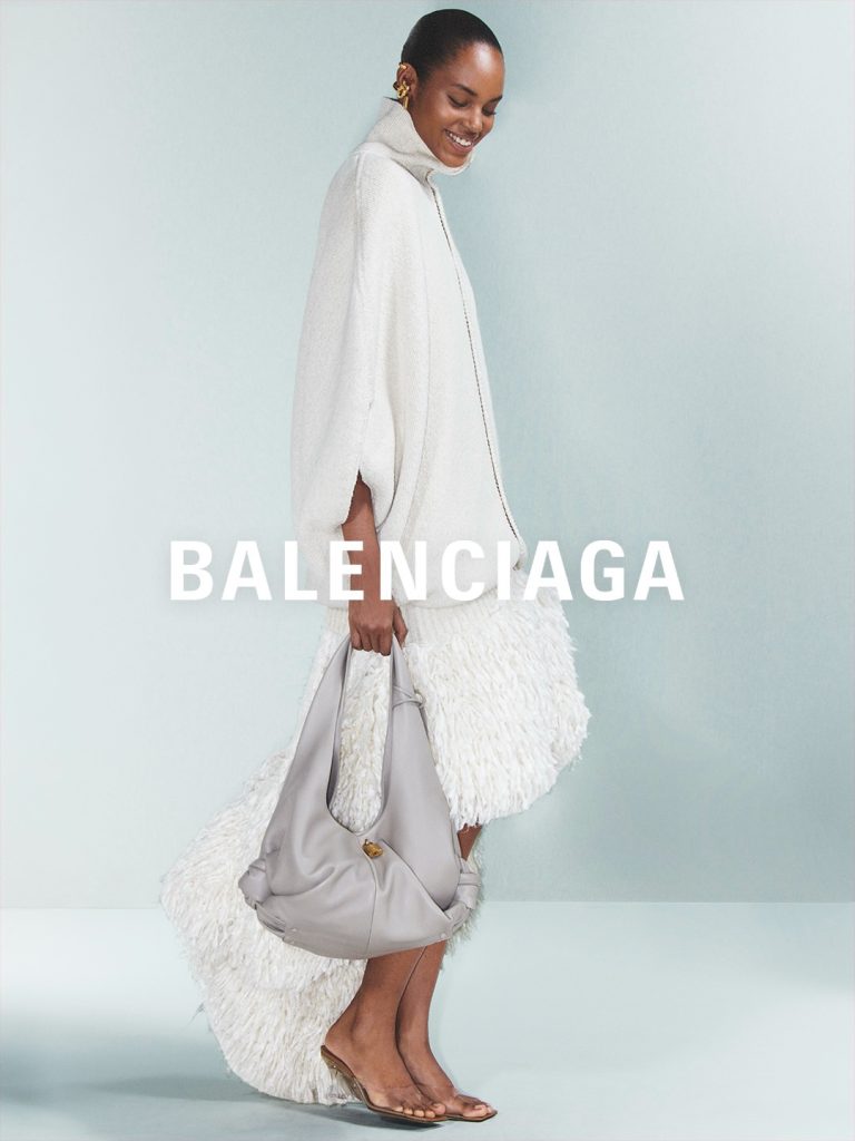 Balenciaga model wearing layered coral tones from Summer 27 range
