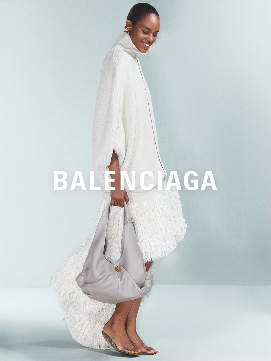 Balenciaga model wearing layered coral tones from Summer 27 range