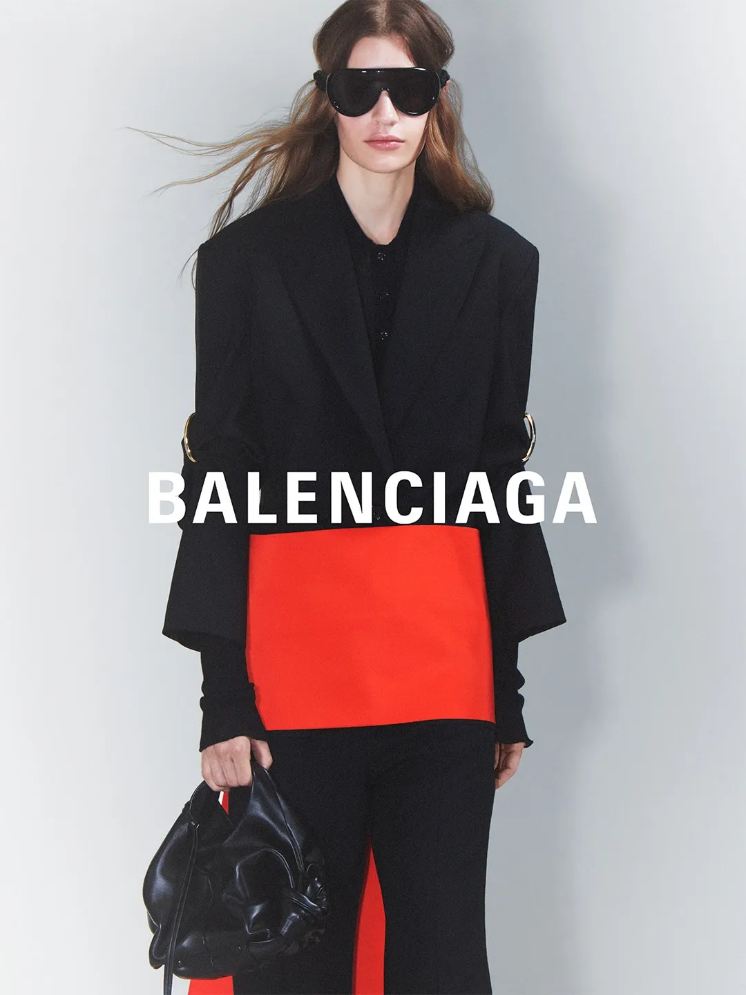 Balenciaga Summer 27 model wearing coral-hued structured jacket with flowing silhouette