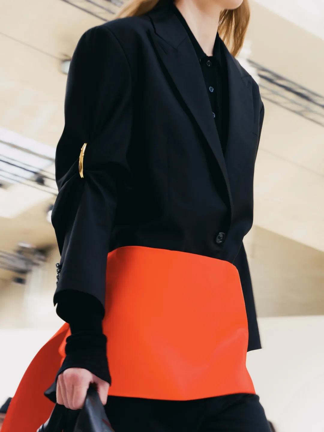 Detail of Balenciaga accessory in coral tones with architectural structure