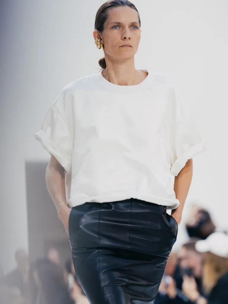 Close-up of textile interplay between crisp suiting and ethereal layered fabric