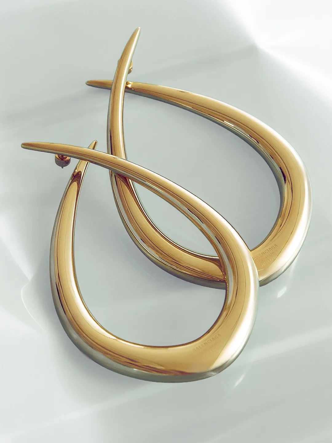 Elegant coral-toned piece demonstrating refined craftsmanship and draping