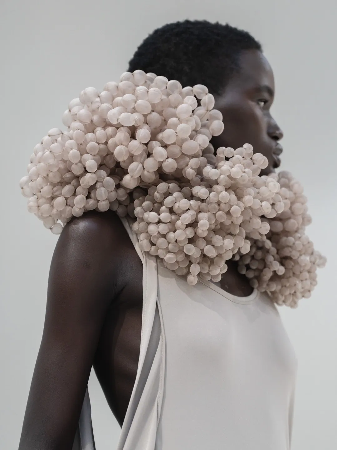 Full-length view of model wearing structured silhouette in collection's signature palette
