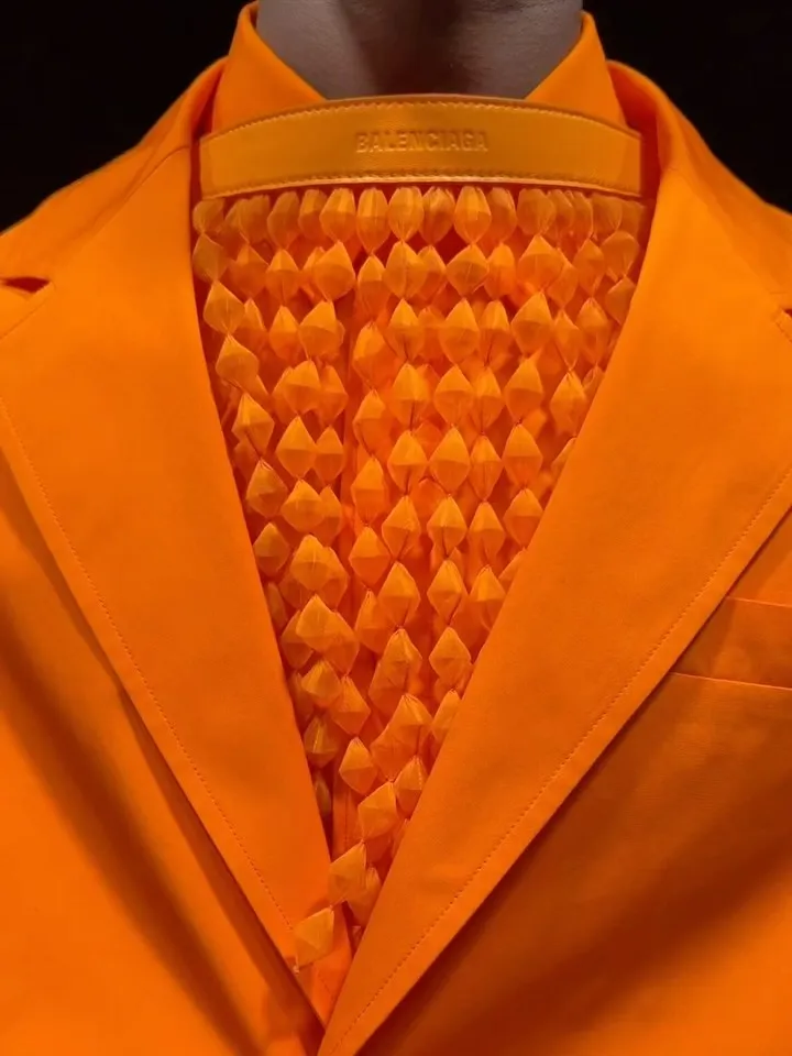 Structured tailored jacket in warm honeyed tone paired with relaxed trousers, embodying oceanic elegance
