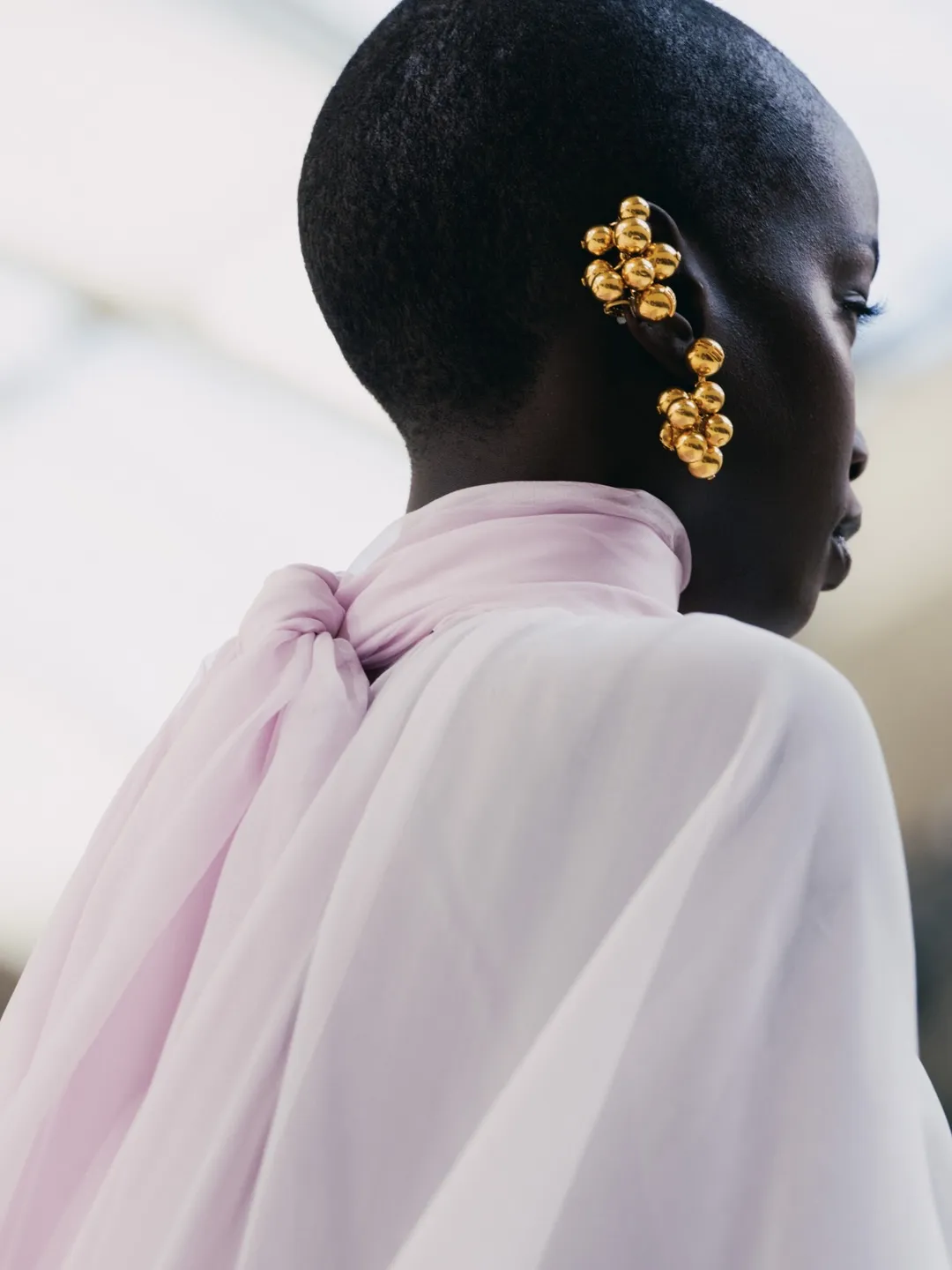 Model in sculptural silhouette demonstrating the interplay between precision tailoring and fluid movement