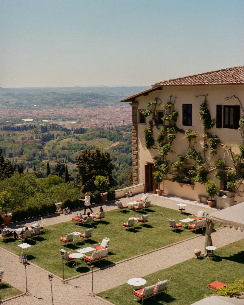 Villa San Michele's breakfast room interior with archways framing views of the city below