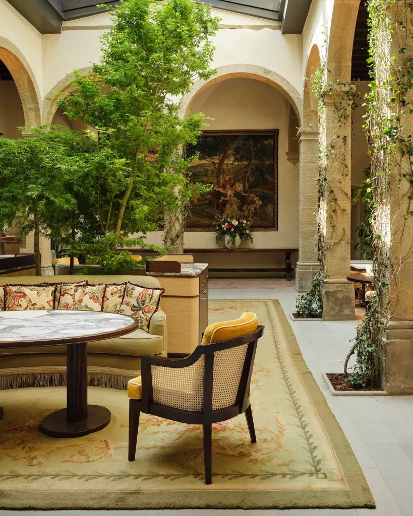 Exterior facade of the restored fifteenth century monastery with Renaissance architecture and manicured gardens