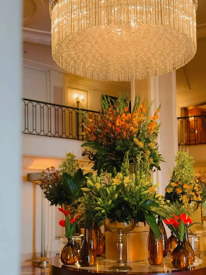 Lush green orchids, yellow gladiolus and vivid anthurium arranged in the Beverly Wilshire lobby