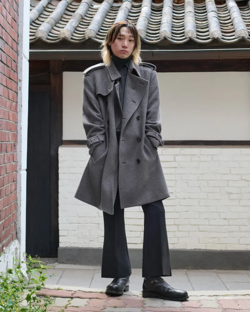Jonathan wearing Burberry's graceful cape in Seoul, illustrating the brand's mastery of dramatic yet sophisticated silhouettes