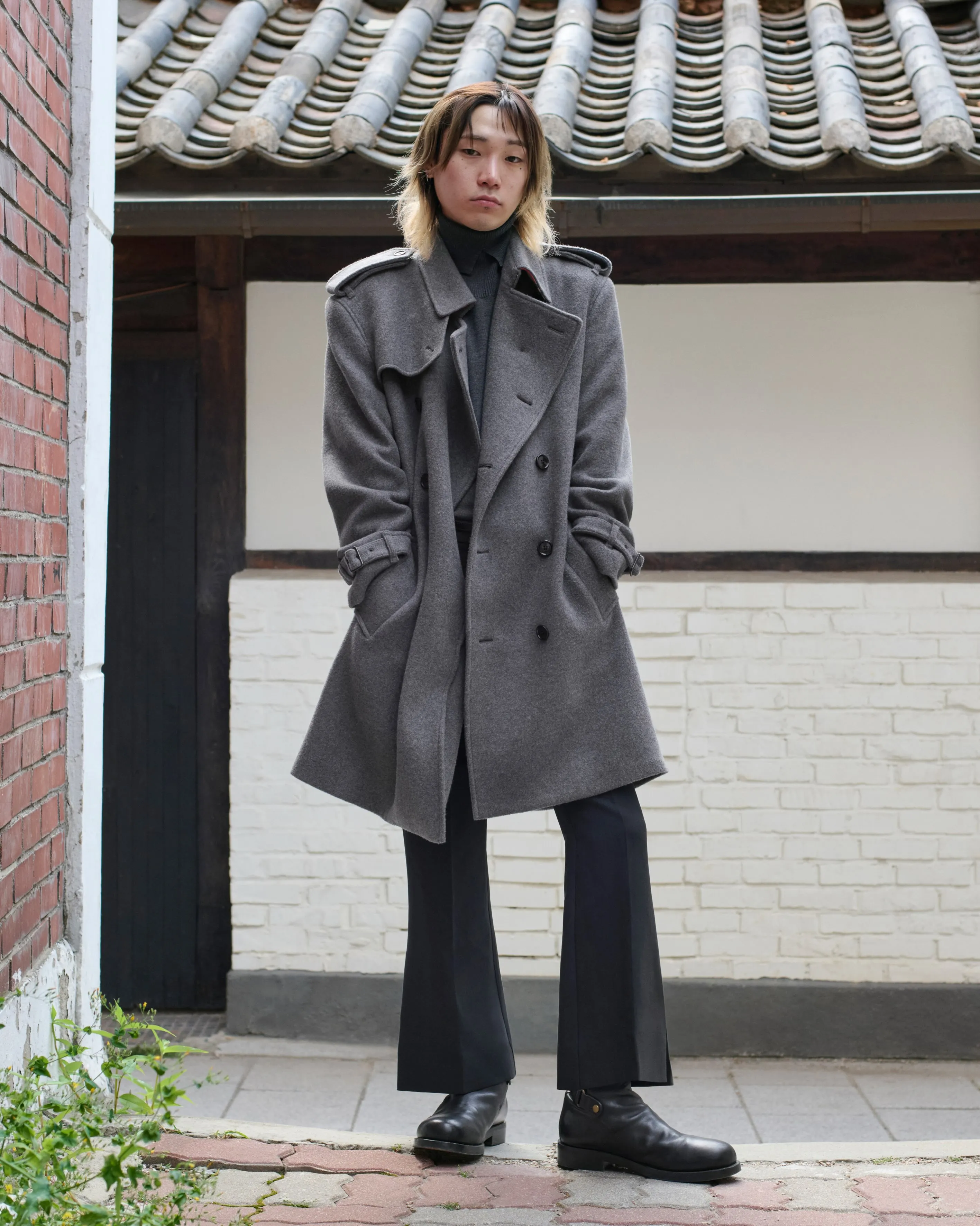 Jonathan wearing Burberry's graceful cape in Seoul, illustrating the brand's mastery of dramatic yet sophisticated silhouettes