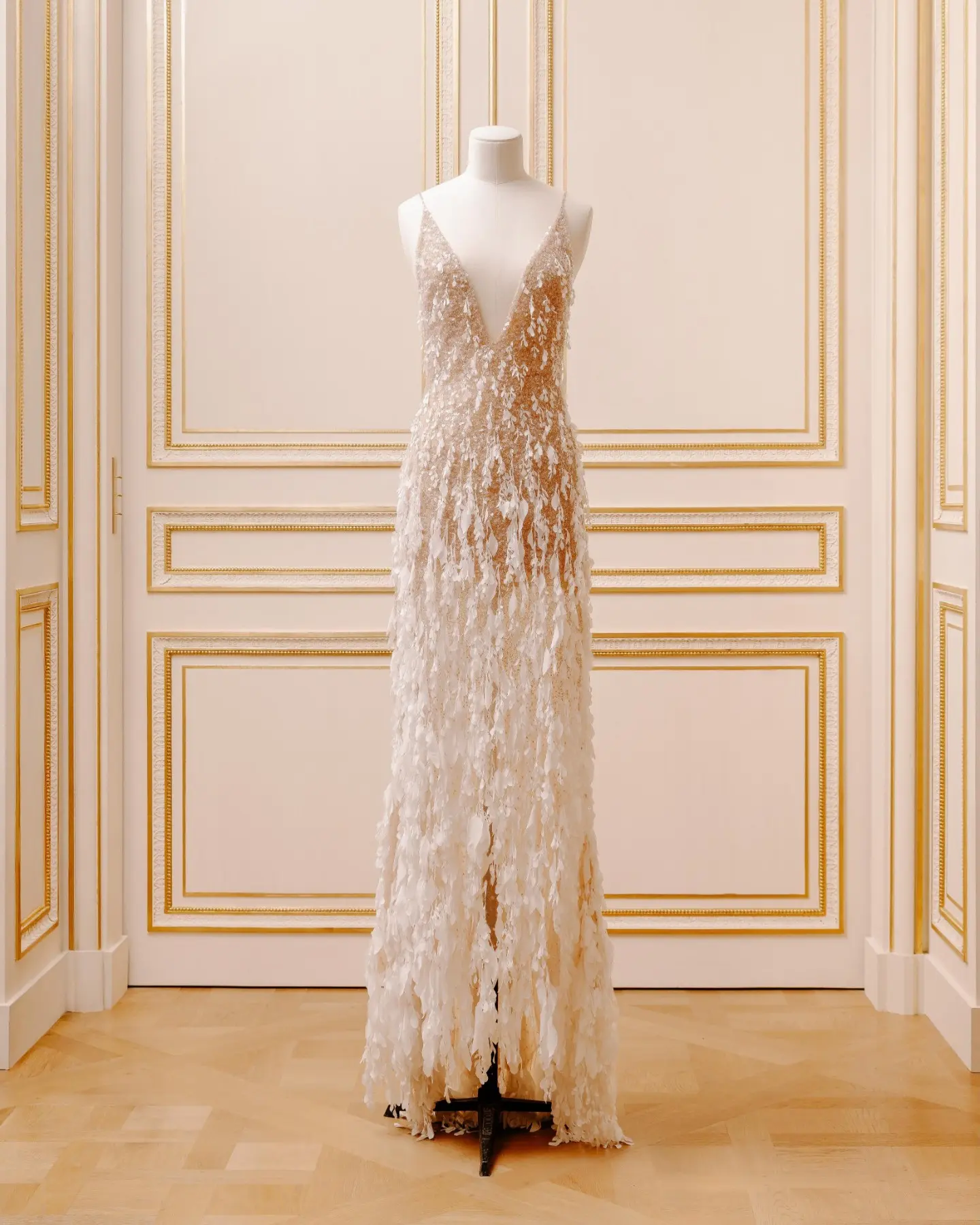 Caroline's Couture nude tulle gown with a cascade of embroidered white flowers