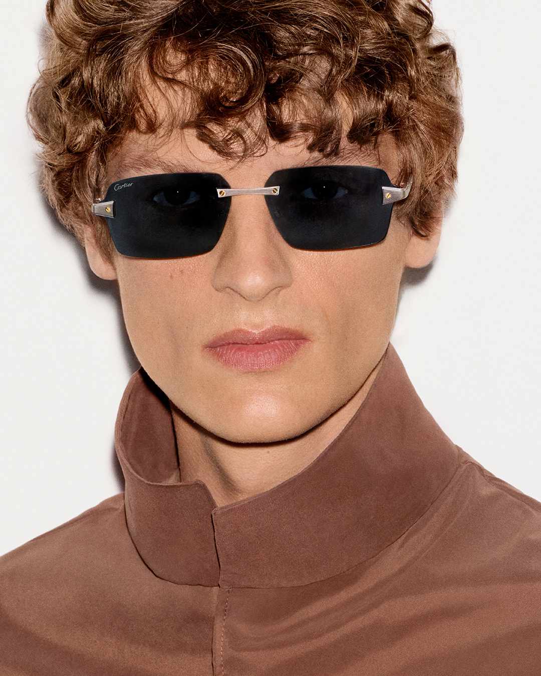 Close-up detail of Santos de Cartier eyewear showcasing precision-engineered titanium construction and signature screws