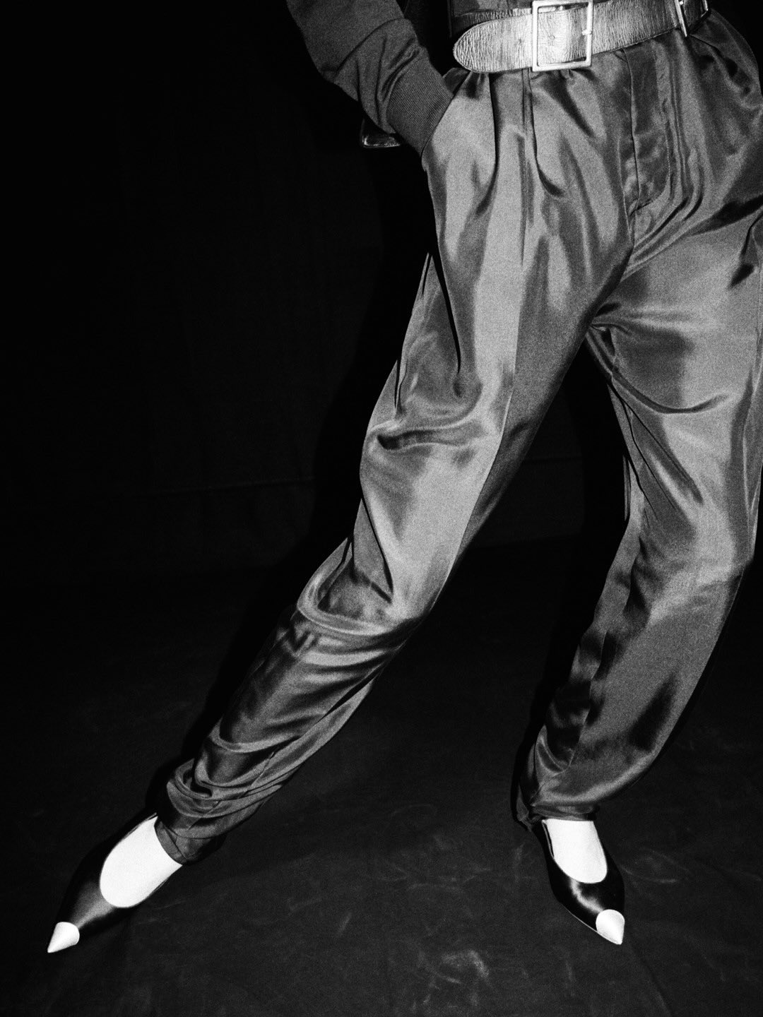 Model in understated white cotton shirt paired with impeccably cut neutral trousers