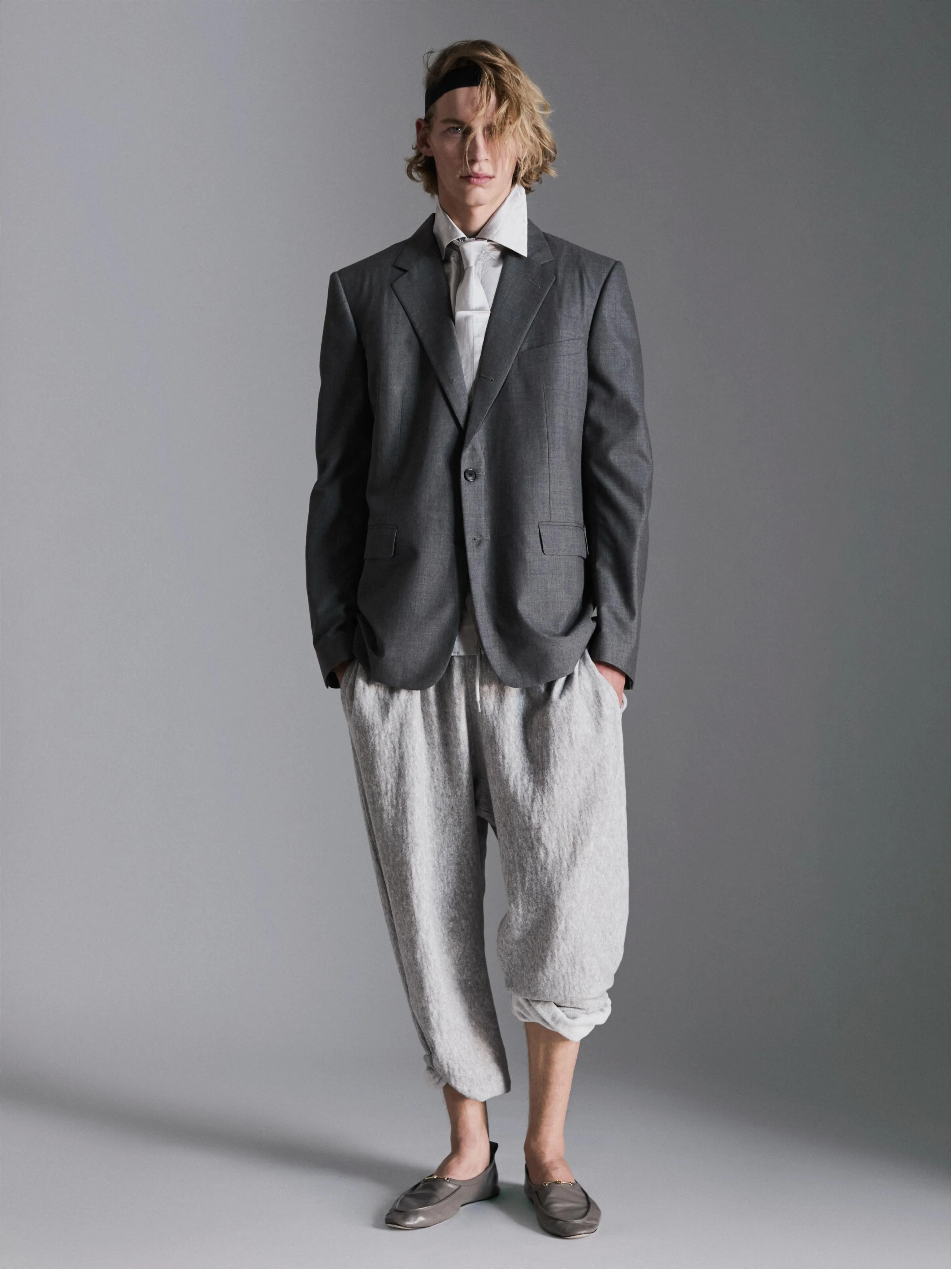 Model in minimalist linen ensemble with refined draping