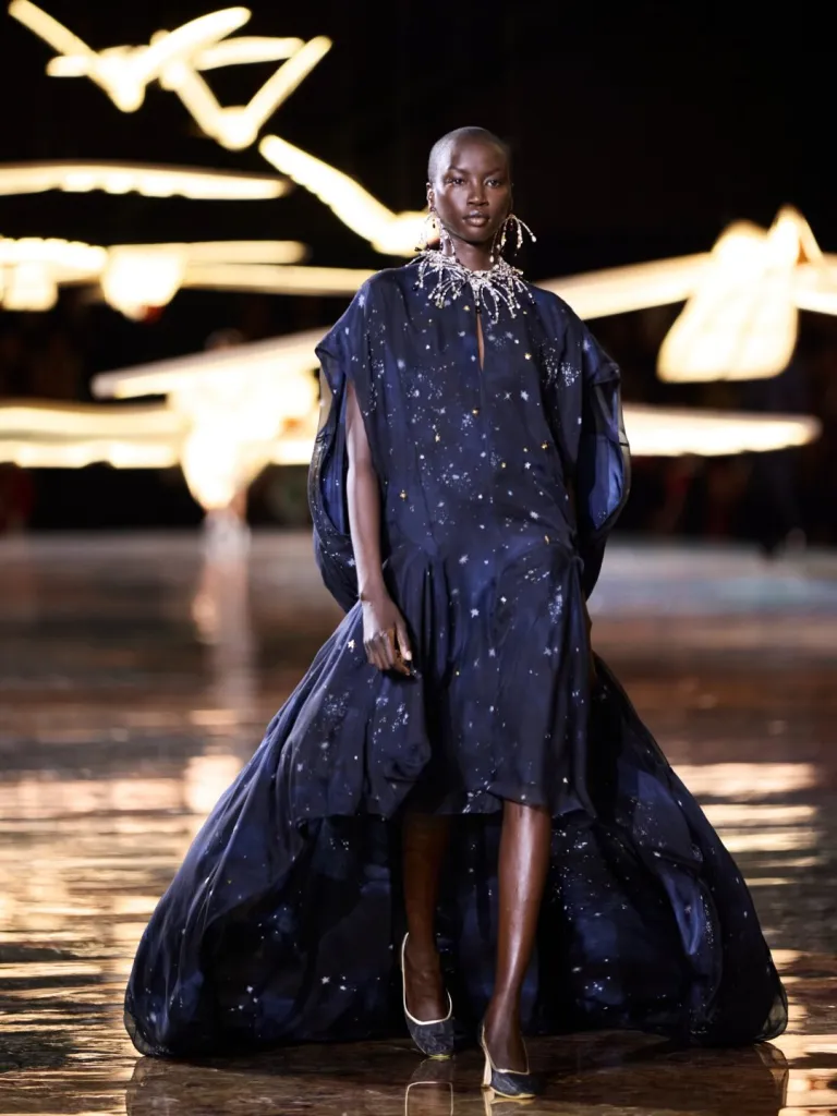 Model in elegant Chanel suiting demonstrating collection's emphasis on graceful movement