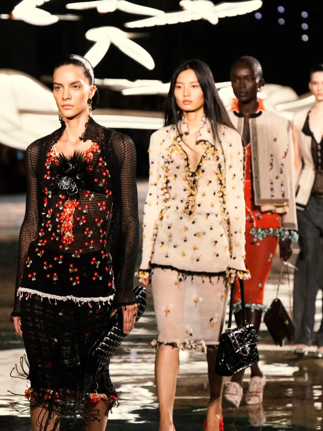 Model wearing Chanel ensemble exemplifying heritage codes and future vision