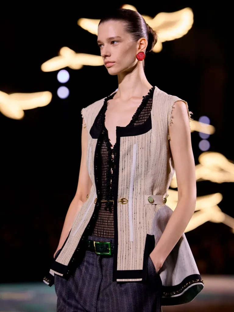 Close-up detail of sheer fabric embroidered with delicate floral motifs in tonal embroidery