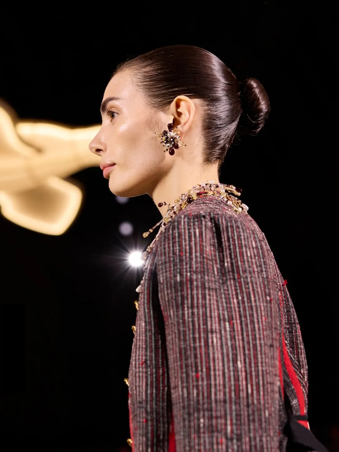 Tailored jacket with intricate button embellishment across the bodice and front placket